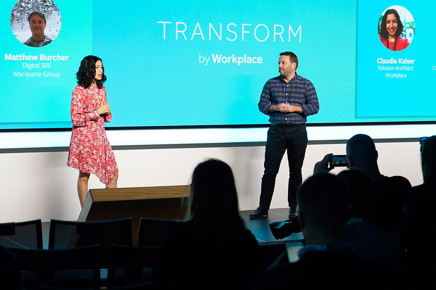 Business team talking at a colleague’s workstation